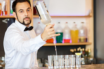 Image showing Barman at work, preparing cocktails.