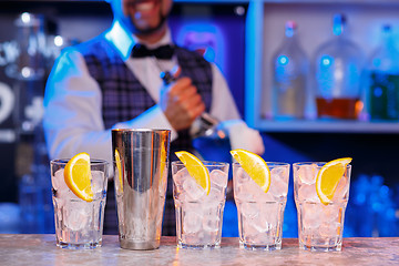 Image showing Barman at work, preparing cocktails.