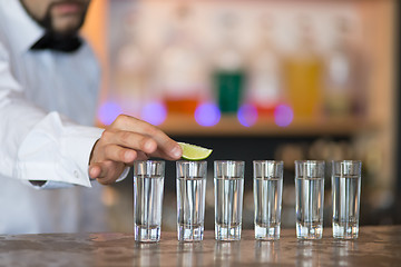 Image showing Barman at work, preparing cocktails.