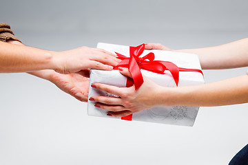 Image showing Hands giving and receiving a present