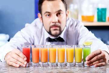 Image showing Barman at work, preparing cocktails.