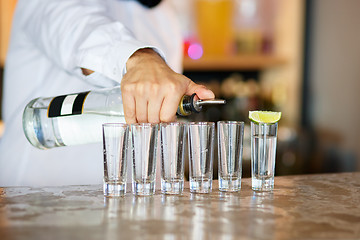 Image showing Barman at work, preparing cocktails.