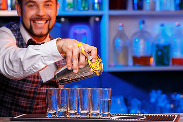 Image showing Barman at work, preparing cocktails.