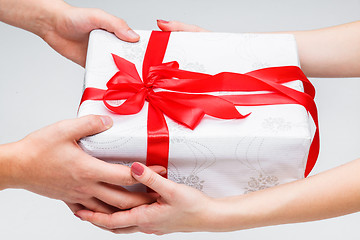 Image showing Hands giving and receiving a present