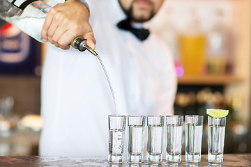 Image showing Barman at work, preparing cocktails.