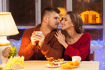 Image showing The  happy young couple with cups of tea 