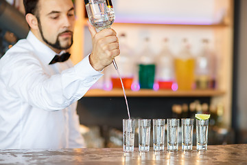 Image showing Barman at work, preparing cocktails.