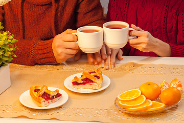 Image showing The  happy young couple with cups of tea 