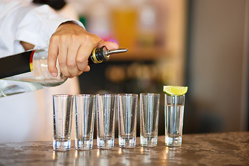 Image showing Barman at work, preparing cocktails.