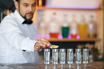 Image showing Barman at work, preparing cocktails.