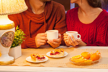 Image showing The  happy young couple with cups of tea 