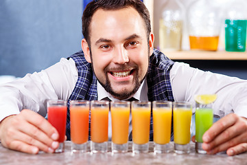 Image showing Barman at work, preparing cocktails.