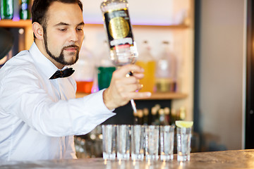 Image showing Barman at work, preparing cocktails.