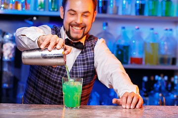 Image showing Barman at work, preparing cocktails.