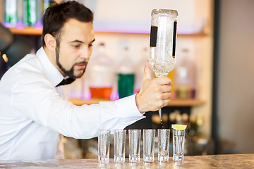 Image showing Barman at work, preparing cocktails.