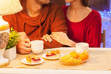 Image showing The  happy young couple with cups of tea 