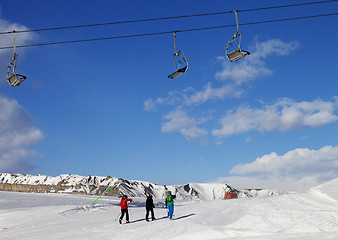 Image showing Three skiers on slope at sun nice day