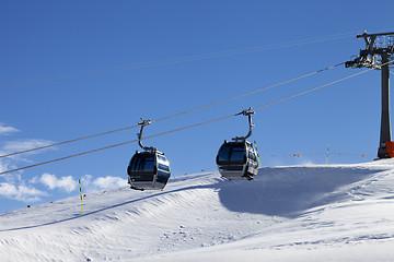 Image showing Gondola lift on ski resort at windy sun day