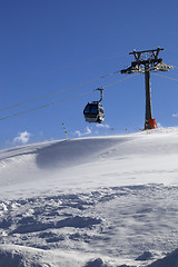 Image showing Gondola lift on ski resort at windy sun day