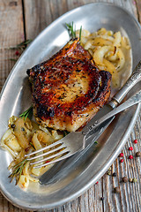 Image showing Pork chop with rosemary and fried onions.