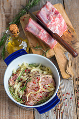 Image showing Pork marinated in olive oil, a mixture of peppers and rosemary.