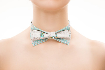 Image showing patterned tie bow on female neck. 