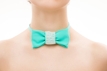 Image showing green tie bow on female neck. 