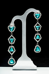 Image showing earrings with blue stones on the black 