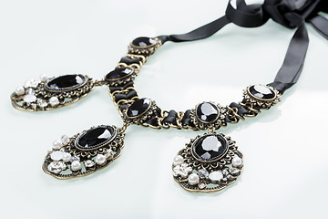 Image showing black necklace with stones on white 