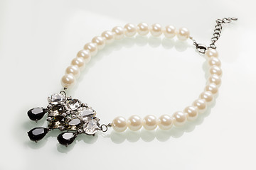 Image showing pearl necklace with black stones on a white 