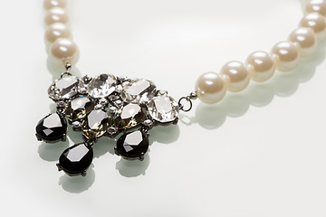 Image showing pearl necklace with black stones on a white 