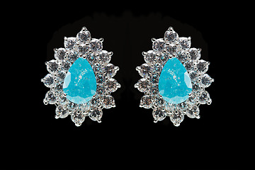 Image showing earrings with blue stones on the black 