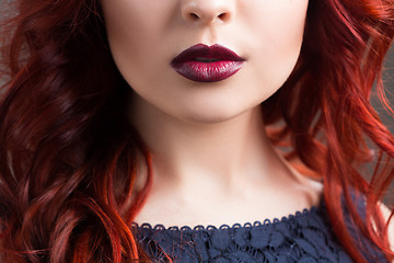 Image showing closeup cherry lips. girl with red hair. the lower part of the face. Fashion Girl Portrait.