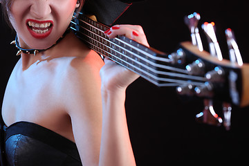 Image showing Fashion girl with guitar playing rock