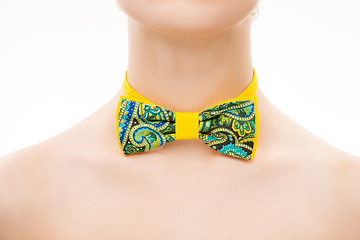 Image showing patterned tie bow on female neck. 