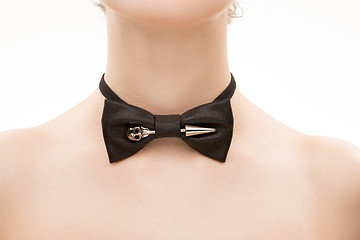 Image showing black tie bow on female neck. 
