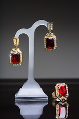 Image showing earring and ring with colorful red gems 