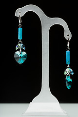 Image showing earrings with blue stones on the black 