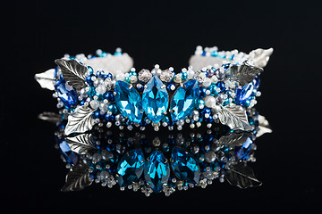 Image showing diadem with large blue stones. bijouterie. on black background