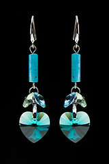 Image showing earrings with blue stones on the black 