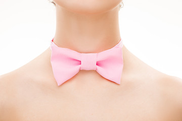 Image showing pink tie bow on female neck. 