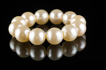 Image showing White pearls on  black  background. luxury bracelet.