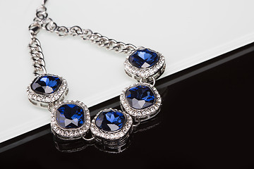 Image showing Bracelet with blue stones over black 