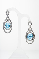 Image showing earrings with blue stones on the white