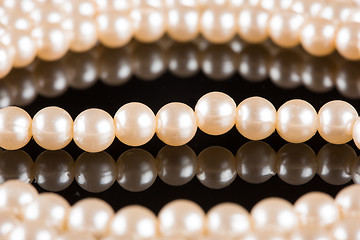 Image showing White pearls on  black  background. luxury necklace.