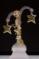 Image showing gold pendant and earrings in the form of stars