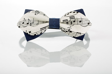 Image showing white bow tie with notes on a white background 