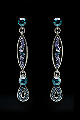 Image showing earrings with blue stones on the black 