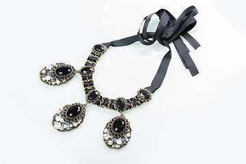 Image showing black necklace with stones on white 