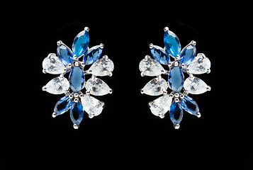 Image showing earrings with blue stones on the black 